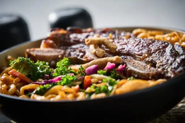 Make these grilled Korean beef short ribs the next time you are craving something bursting with sweet and savory flavor! Ribs cut Flanken style take less than 10 minutes to grill. Serve on top of the Korean Sesame Hot or Cold Salad and Noodle Meal Kit for a restaurant quality meal. Delicious!